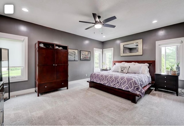 bedroom with light colored carpet and ceiling fan