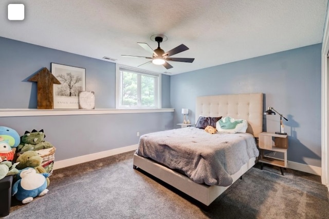 carpeted bedroom with ceiling fan and a textured ceiling