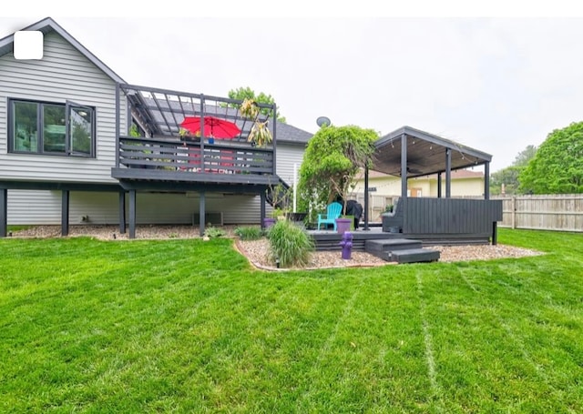 back of property featuring a deck and a lawn