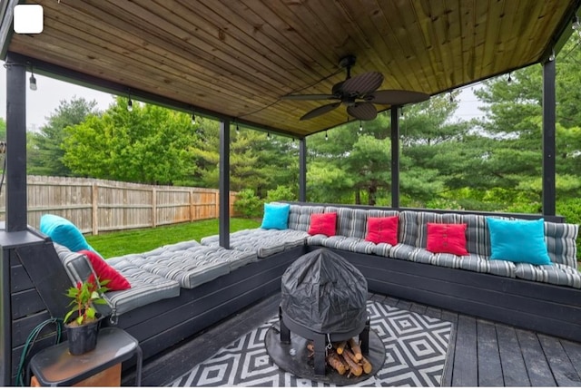 deck with an outdoor living space and ceiling fan