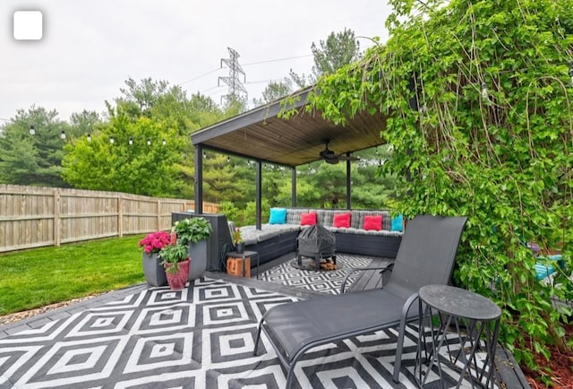 view of patio / terrace with an outdoor living space and ceiling fan