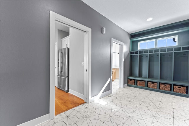 mudroom with light tile patterned floors