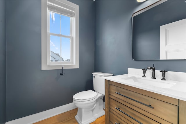 bathroom featuring vanity, toilet, and hardwood / wood-style flooring