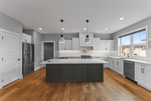 675 Daybreak Dr, Waukee, IA 50263 - kitchen with appliances with stainless steel finishes, a center island, light countertops, and a sink