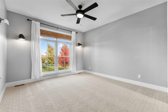 carpeted empty room featuring ceiling fan