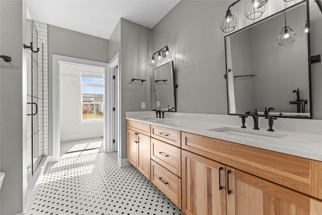 675 Daybreak Dr, Waukee, IA 50263 - bathroom with a stall shower, double vanity, a sink, and baseboards