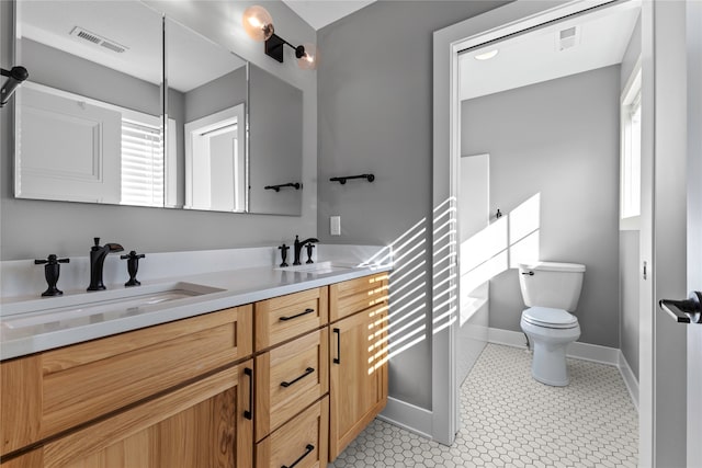 bathroom with vanity, toilet, and tile patterned flooring