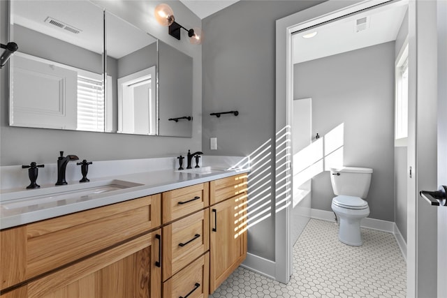 675 Daybreak Dr, Waukee, IA 50263 - bathroom with double vanity, visible vents, toilet, and a sink