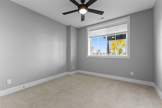 carpeted empty room featuring ceiling fan