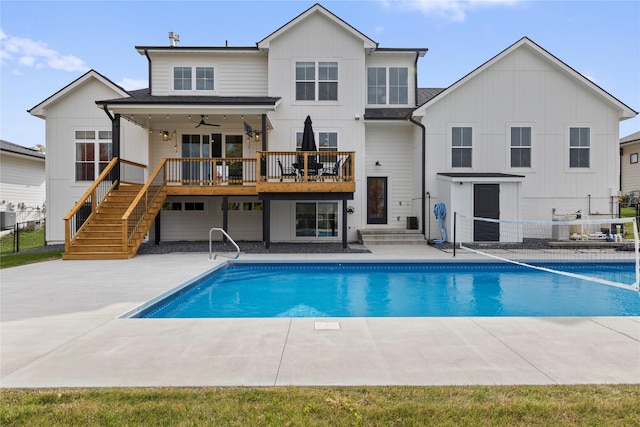 675 Daybreak Dr, Waukee, IA 50263 - back of house with a patio, stairway, a fenced in pool, board and batten siding, and fence