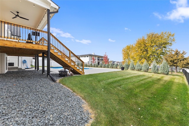 675 Daybreak Dr, Waukee, IA 50263 - view of yard featuring a patio, ceiling fan, stairs, an outdoor pool, and a deck
