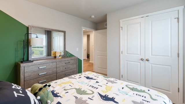 bedroom featuring light wood-type flooring and a closet