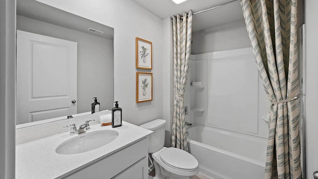 full bathroom with vanity, shower / bath combo with shower curtain, and toilet