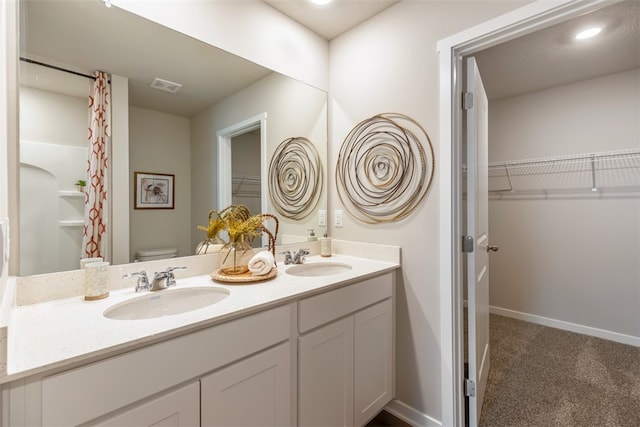 bathroom with toilet and vanity