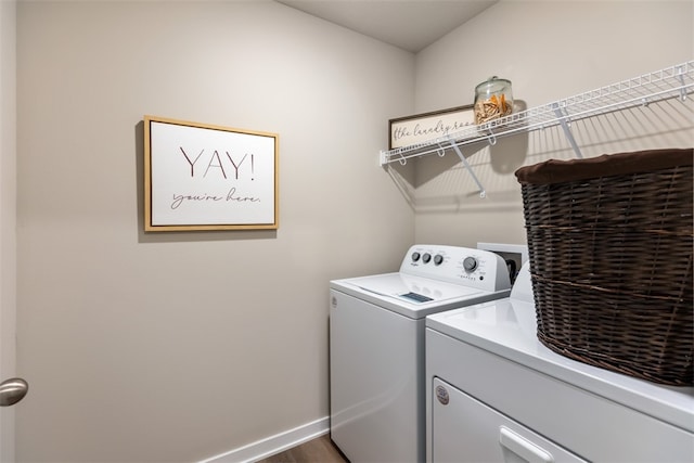 laundry room featuring washer and dryer and dark hardwood / wood-style floors