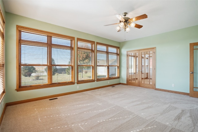 carpeted empty room with ceiling fan