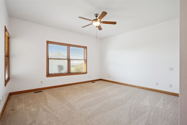 spare room with ceiling fan and carpet floors