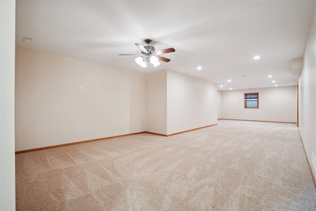 unfurnished room featuring light carpet and ceiling fan