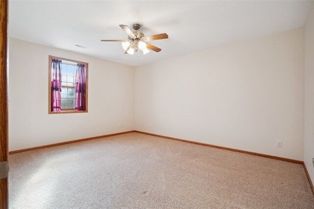 carpeted empty room featuring ceiling fan