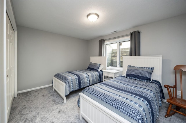 carpeted bedroom with baseboards and visible vents