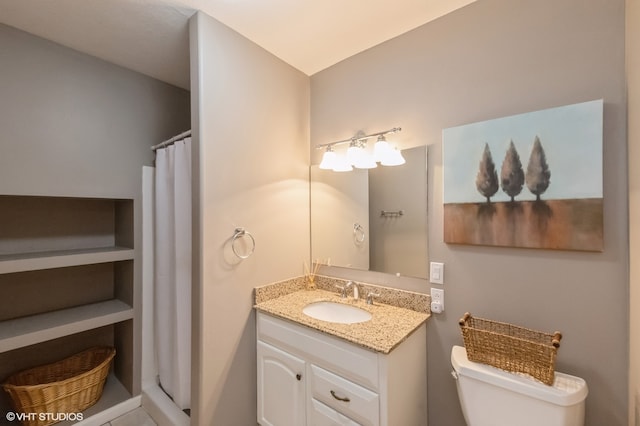 bathroom featuring vanity, toilet, and a shower with curtain