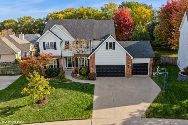 view of front of property with a front yard and a garage