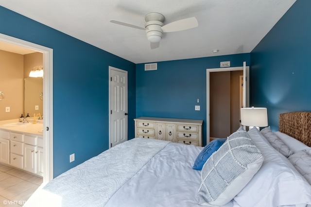 tiled bedroom with connected bathroom, ceiling fan, and sink