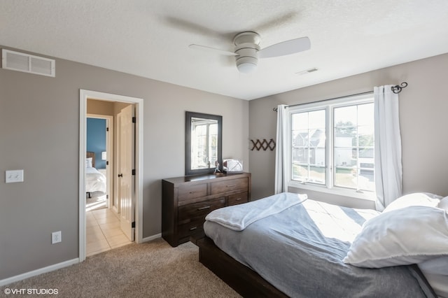 carpeted bedroom with a textured ceiling and ceiling fan