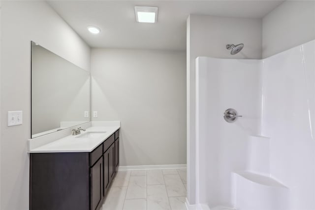 full bathroom with a shower, marble finish floor, vanity, and baseboards