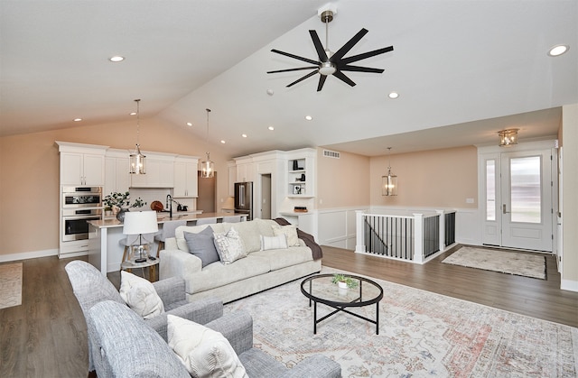 living room featuring lofted ceiling, ceiling fan, sink, and dark hardwood / wood-style flooring