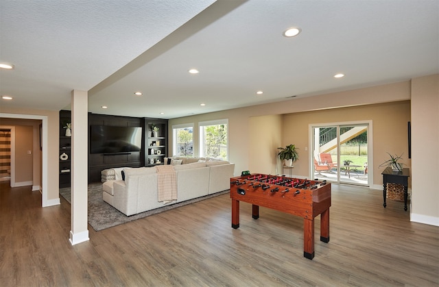 game room with hardwood / wood-style floors and a wealth of natural light