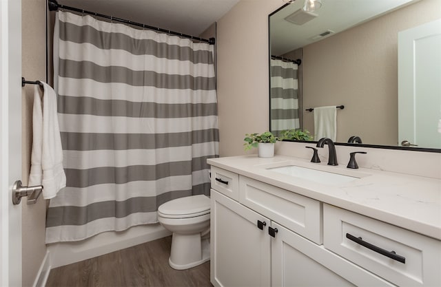 full bathroom featuring vanity, shower / bath combo, wood-type flooring, and toilet