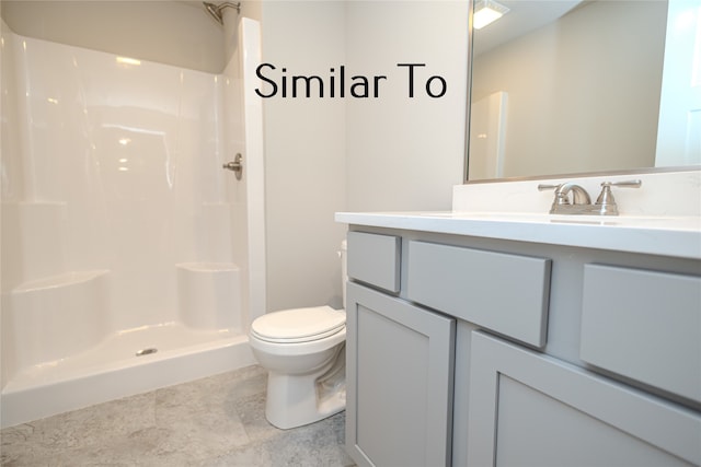 bathroom with toilet, vanity, and a shower