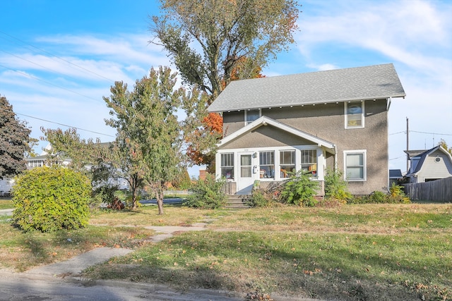 exterior space featuring a front yard and a sunroom