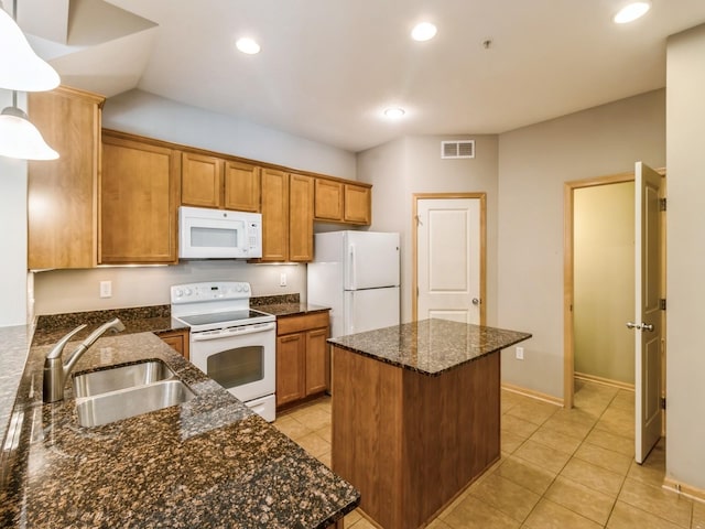 kitchen featuring pendant lighting, white appliances, dark stone counters, sink, and light tile patterned floors