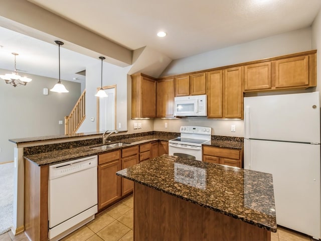 kitchen featuring white appliances, dark stone counters, sink, decorative light fixtures, and light tile patterned flooring