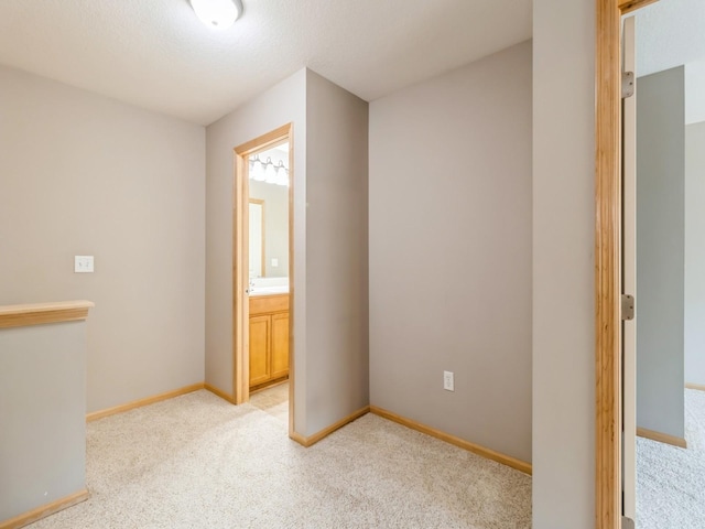 carpeted empty room with a textured ceiling