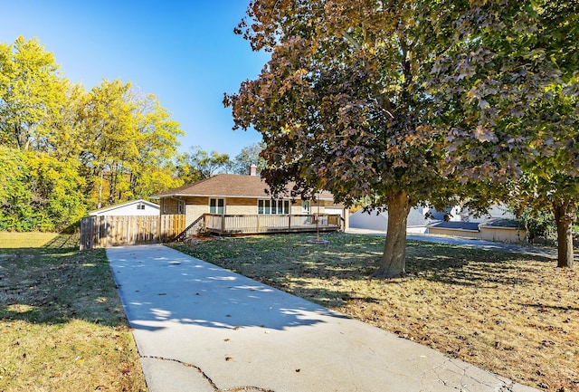 view of front facade featuring a front yard and a deck