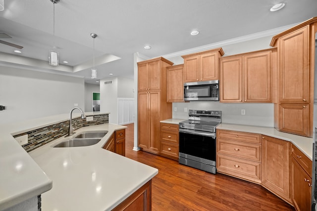 kitchen featuring appliances with stainless steel finishes, a sink, and light countertops