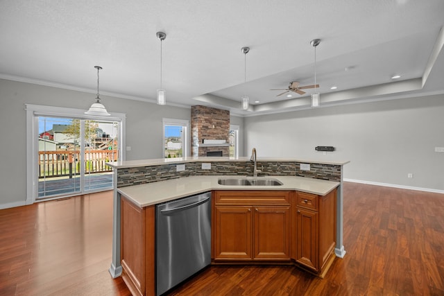 kitchen with a sink, light countertops, dishwasher, open floor plan, and an island with sink