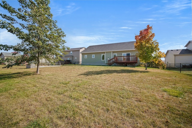 view of yard with a deck and fence