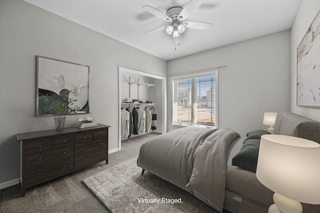 bedroom with light colored carpet, baseboards, a walk in closet, ceiling fan, and a closet