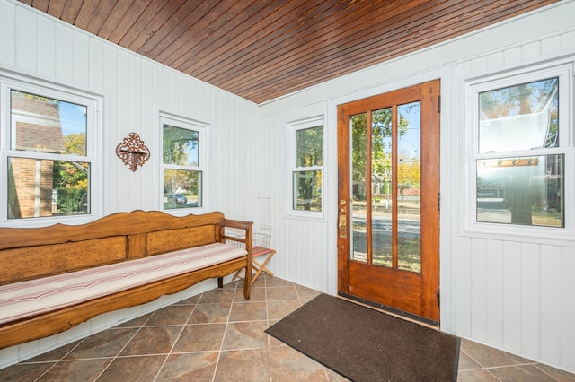 entryway featuring wooden walls, wooden ceiling, and tile patterned flooring