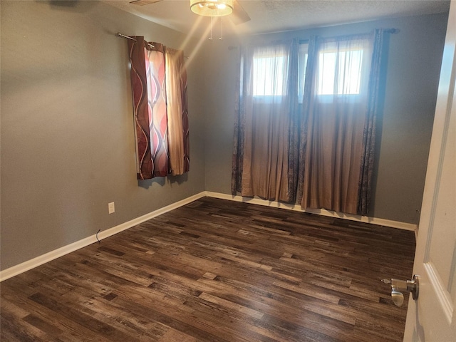 700HICKORYST Hickory St, Creston, IA 50801 - unfurnished room featuring baseboards, a ceiling fan, dark wood-style flooring, and a textured ceiling