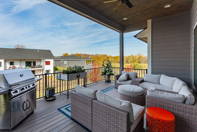 wooden terrace with an outdoor living space, area for grilling, and ceiling fan