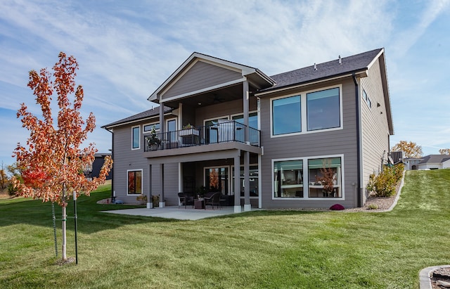 rear view of house with a patio, a yard, central air condition unit, and a balcony