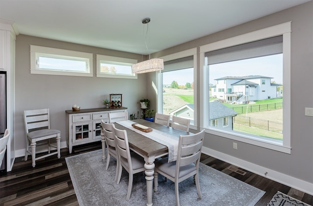 dining space with dark hardwood / wood-style floors