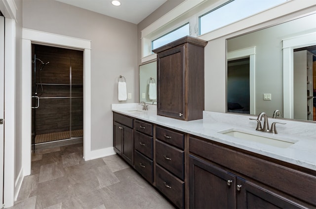 bathroom with vanity and a shower with shower door