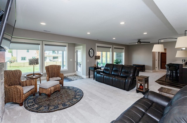 carpeted living room with ceiling fan