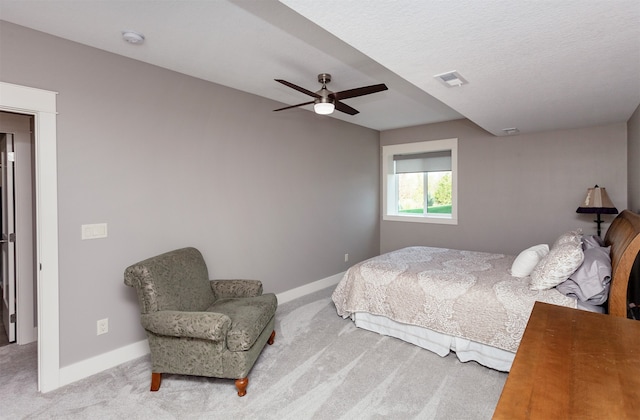 bedroom featuring carpet floors, a textured ceiling, and ceiling fan